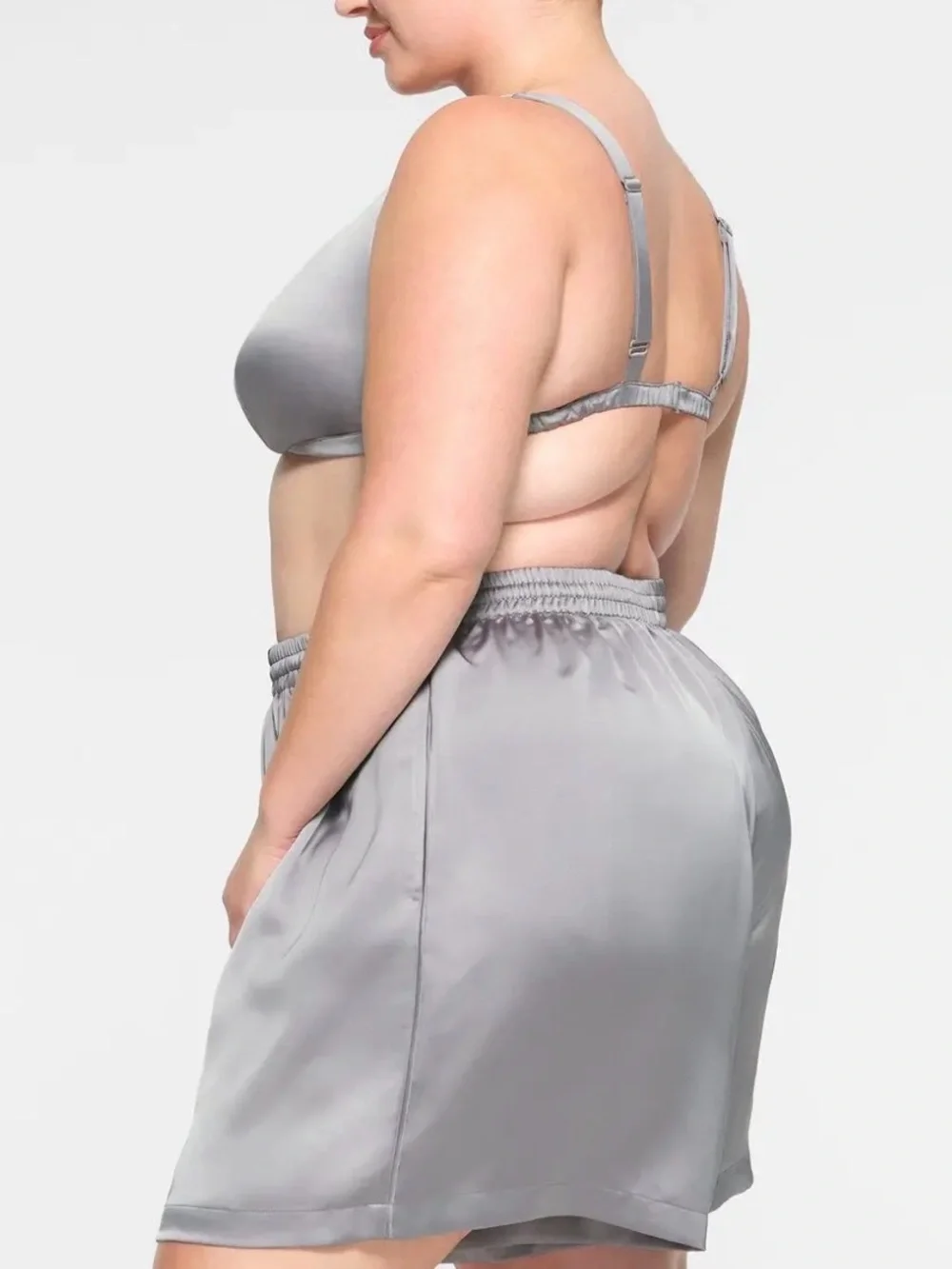 SKIMS Sporty Satin Loose Short in the metallic silver shade called Mirror